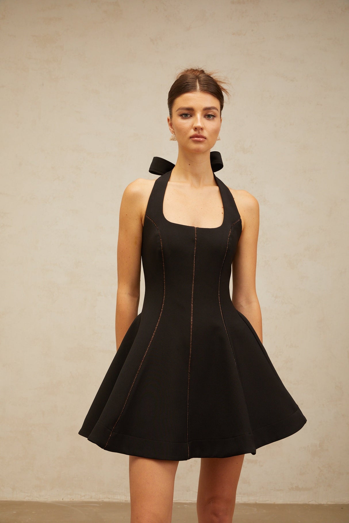 Aurohaya Quirine halterneck bow-detail mini dress in Black