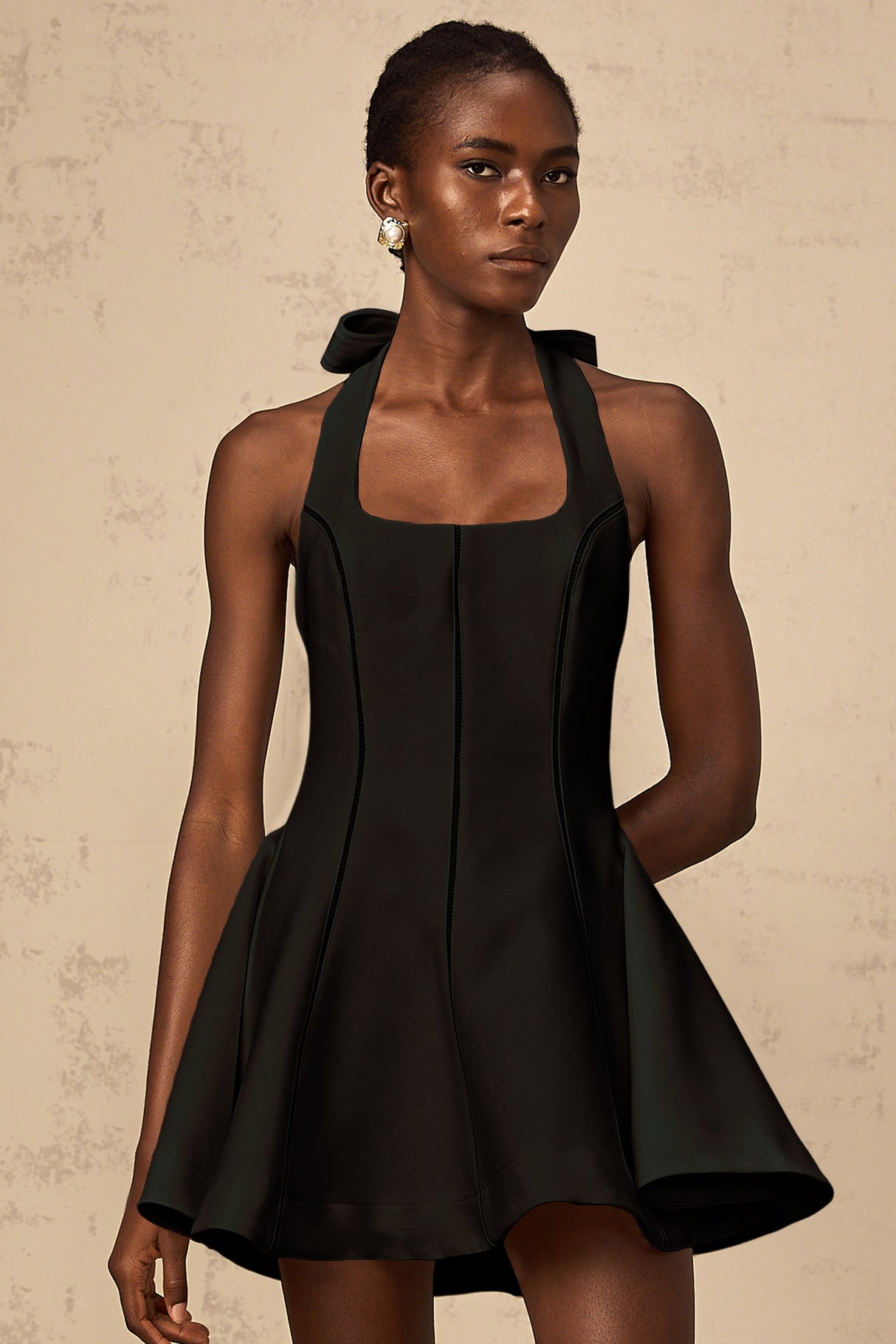 Aurohaya Quirine halterneck bow-detail mini dress in Black